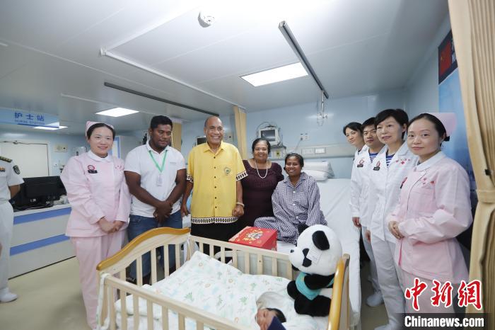 基里巴斯總統(tǒng)馬茂與海上醫(yī)院醫(yī)護人員、新生兒家人合影。　黎宇 攝