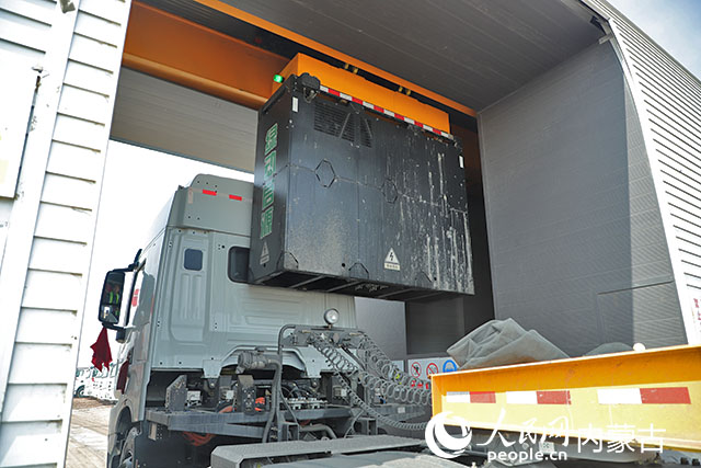 萬(wàn)利新能源數(shù)字陸港里，正在充換電站進(jìn)行換電的重卡。人民網(wǎng)記者 趙夢(mèng)月攝