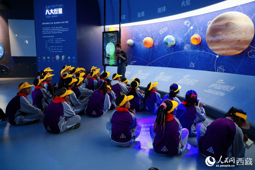 在藏域星球天文體驗館內(nèi)，科普工作人員正通過巨型環(huán)幕為學生們生動講解天文知識。人民網(wǎng)記者 次仁羅布攝