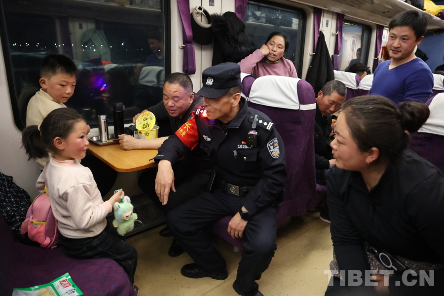乘警長左紅彬在巡視車廂間隙，向攜帶兒童的旅客專門叮囑安全注意事項(xiàng)。.JPG