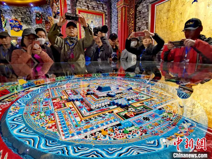 圖為參觀者拍攝壇城?！?zhí)砀?攝